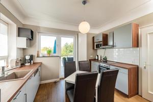 a kitchen with a sink and a table with chairs at Villa P18 in Bad Liebenstein