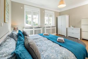 a bedroom with a large bed with blue sheets at Villa P18 in Bad Liebenstein