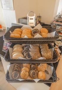 three trays filled with different types of donuts at Hotel Joh in Bad Salzuflen