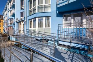 a blue building with metal stairs in front of it at Apartament Kasprowicza in Kołobrzeg