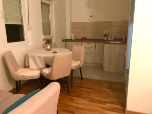 a kitchen with a table and chairs in a room at Apartments Premović Nikšić in Nikšić