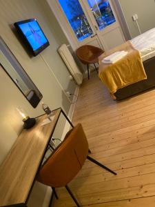 Zimmer mit einem Tisch, Stühlen und einem TV in der Unterkunft Hotell & Bistro Rödesund in Karlsborg