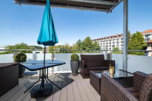 a patio with a table and an umbrella at Villa P18 in Bad Liebenstein