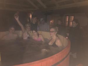 a group of people sitting in a hot tub at Árpád nyaralóház in Sarud