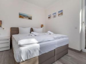 Ein Bett oder Betten in einem Zimmer der Unterkunft Villa Vogue Wohnung Nr. 11