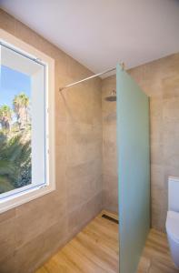 a bathroom with a toilet and a window at Fortuna in Los Caños de Meca +37 photos
