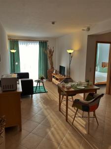 a living room with a table and a couch at Herzmuschel Gollwitz in Insel Poel