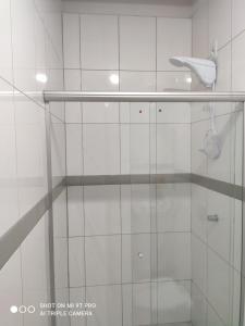 a shower with a glass door in a bathroom at Casa aconchegante perto da Uel in Londrina