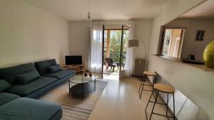 a living room with a couch and a table at Lovely Suite Nimes Romaine in Nîmes