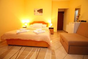 a bedroom with a bed with two towels on it at Apartments Mitrovići Miločer in Sveti Stefan