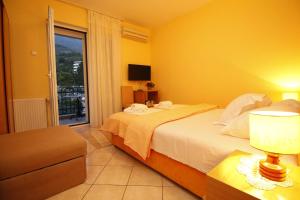 a hotel room with a bed and a window at Apartments Mitrovići Miločer in Sveti Stefan