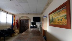 a hallway with a large painting on the wall at Domus Viatoris in Sahagún