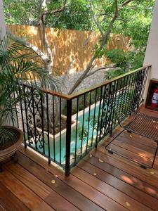 a balcony with a pool and a fence at TreeHouse Boutique Hotel, an adults only boutique hotel in Mérida