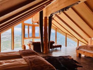 a room with a bed and a large window at Lodge am Krippenstein in Obertraun