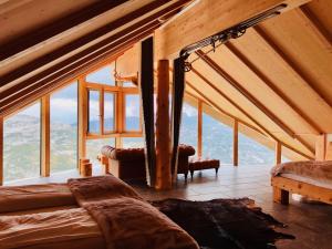 Zimmer mit einem Bett und einem großen Fenster in der Unterkunft Lodge am Krippenstein in Obertraun