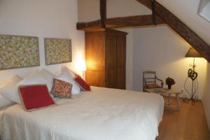 1 dormitorio con 1 cama blanca grande y 2 almohadas en Le Moulin 1826, en Houdan