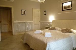 a bedroom with a bed with two towels on it at Brunelleschi suite in Florence