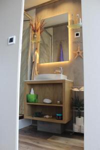 a bathroom with a sink and a mirror at Floating house BRAVIA in Portorož