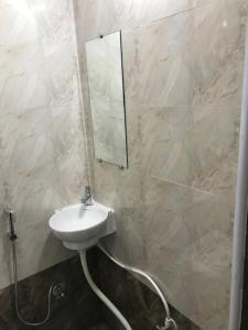 łazienka z umywalką i lustrem na ścianie w obiekcie Prestige Guest House & Hostel w mieście Bilaspur