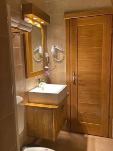 a bathroom with a sink and a mirror and a toilet at Princess Nina Kolašin in Kolašin +40 photos