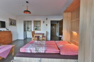 a bedroom with a large bed and a table at Ferienwohnung Alpenfreude in Missen-Wilhams