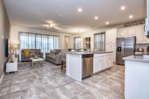cocina y sala de estar con sofá y mesa en 5 Bedrooms Townhome w- Splashpool - 8205SA, en Orlando