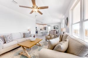 a living room with couches and a ceiling fan at Latitude Adjustment in Dauphin Island