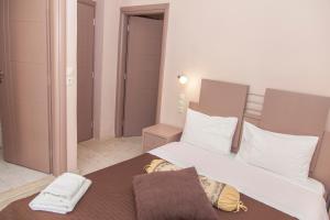 a bedroom with a large white bed with white pillows at Fantastic Matala 1 in Matala