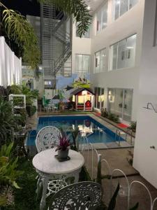 a patio with a table and chairs next to a pool at Our Story Boutique Hotel in Cagayan de Oro