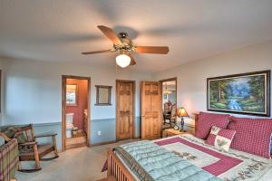 a living room with a ceiling fan and a couch at Home with Spacious Deck, BBQ, Game Room and Lake Views in Hiawassee