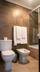 a bathroom with a toilet and a sink at Guido 1980 by Ayres Apartments Recoleta in Buenos Aires