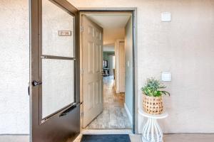 an open door to a hallway with a potted plant at Driftwood Escape in Saint Augustine Beach +42 photos