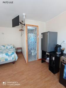 a bedroom with a bed and a bathroom with a toilet at Casa Ananda in Punta de Choros