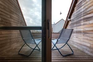 a chair sitting on a balcony next to a window at Villa Louise Oostende in Ostend
