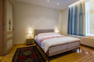 a bedroom with a large bed and a window at Villa Louise Oostende in Ostend