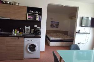 a small room with a bed and a washing machine at Seaview apartment - Clara Sarafovo - 100m to sea in Burgas