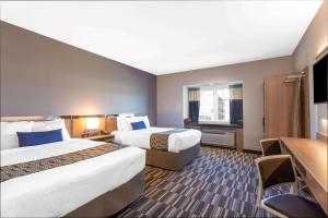 Ένα ή περισσότερα κρεβάτια σε δωμάτιο στο Microtel Inn Suites by Wyndham South Hill +16 φωτογραφίες