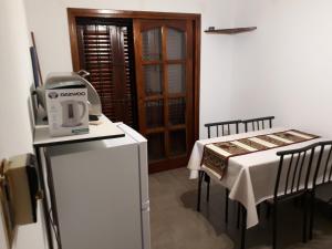 a kitchen with a table with a coffee machine on a counter at Departamentos Maryan in San Luis