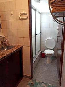 a bathroom with a toilet and a sink at Departamentos Maryan in San Luis +19 photos