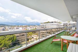 a balcony with a view of a city at Coup de coeur! Vue mer! Terrasse dangle! in Antibes