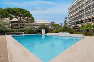 a large swimming pool in front of a building at Coup de coeur! Vue mer! Terrasse dangle! in Antibes
