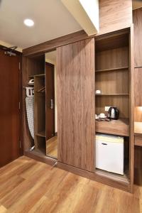 a kitchen with wood paneling and a cupboard at YANGTZE HOTEL 长江酒店 in Johor Bahru