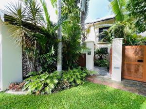 a house with palm trees in front of it at Lahania Lux Beach Villa in Clifton Beach