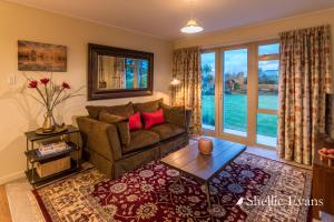 a living room with a couch and a table at Night Sky Cottages - Kea Cottage - LUXURY in Twizel