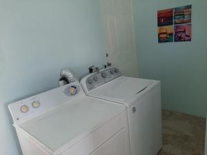 a white washer and dryer in a room at The Cozy Corner in Nassau