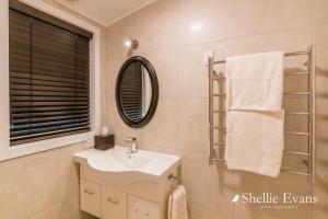 a bathroom with a sink and a mirror at Night Sky Cottage - Kahu Cottage - HOT TUB in Twizel +38 photos