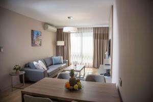 a living room with a couch and a table with fruit on it at Best Western Premier Plovdiv Hills in Plovdiv