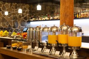 a bar with some pitchers of orange juice at Peppers Cradle Mountain Lodge in Cradle Mountain