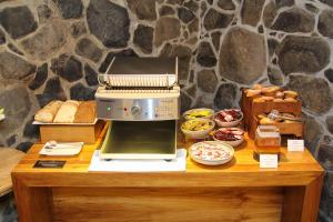 a table with a microwave and some bread and pastries at Peppers Cradle Mountain Lodge in Cradle Mountain