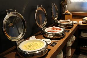 a buffet with several plates of food and mirrors at Peppers Cradle Mountain Lodge in Cradle Mountain